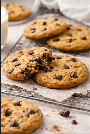 Freshly baked artisan chocolate chunk cookies on a cooling rack